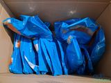 a cardboard box filled with blue bags of food