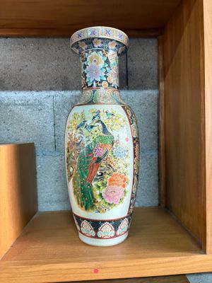 a vase that is sitting on a shelf in a room
