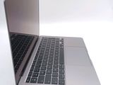 a silver laptop with a black keyboard on a white surface