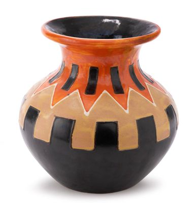 a black and orange vase sitting on a white surface