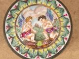 a small plate with a picture of two angels on it