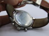a person that is holding a watch in their hand