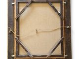 an old picture frame with a rope hanging from it ' s sides