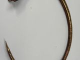 a close up of a metal snake on a white surface