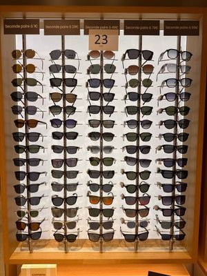 many pairs of sunglasses on display in a display case