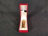 an image of a gold ring in a red box on a black background