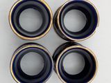 four blue and gold vases sitting on top of a white table