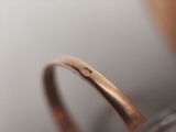 a close up photo of a ring with a diamond on it