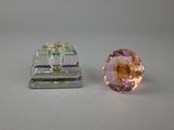 pair of clear and pink crystal beads on a white surface