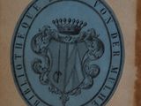 a plaque on the wall of a building that has a coat of arms on it