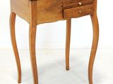 a small wooden table with a drawer on top of it