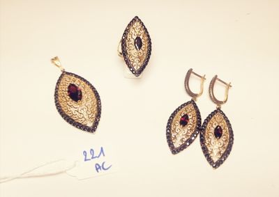 two pairs of earrings and a pair of earrings on a white surface