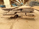 many pieces of wood stacked on top of each other in a warehouse