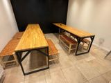 two benches and a table in the corner of a room