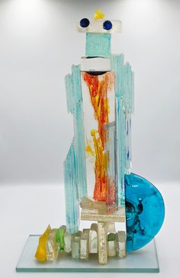 a glass sculpture of a building with a fire inside of it