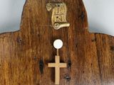 a wooden clock with a cross on the front of it