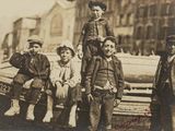 a group of men standing next to each other in front of a boat