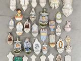 a lot of religious figurines on display on the wall