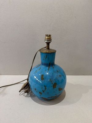 un petit vase bleu surmonté d'une lampe