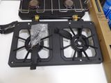 a black stove top with two burners on top of it