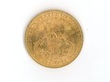 a gold coin with a crown on it on a white surface