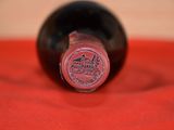 a close up of a bottle of wine on a red cloth