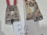 two red and black wire clamps on a white table