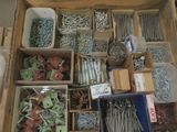 many different types of screws and nails in a box