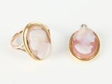 two gold rings with pink and white stone in them