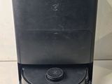 a close up of a black coffee machine on a white surface