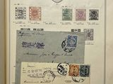 an open book with a bunch of stamps on it sitting on top of a table