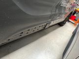 a car that has been painted black in a garage