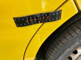 the back end of a yellow car with a sticker that says vauco