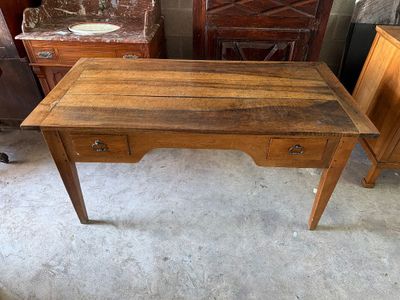 a wooden desk with drawers and a mirror in the corner