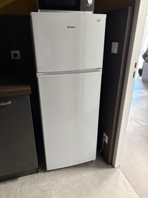 a white refrigerator and a microwave in a kitchen