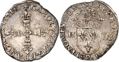 a silver coin with a shield on the front and a shield on the back
