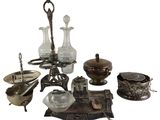 a lot of silver and glass items sitting on a table