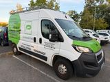 a green and white van that is parked in a parking lot