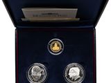 a box with three silver coins in it and a card