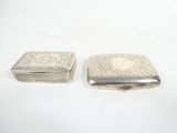 two small silver boxes sitting on top of each other on a white surface