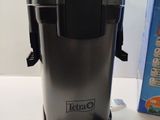 a black and silver coffee maker next to a blue and white box