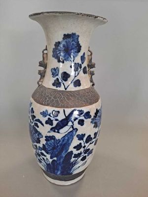a blue and white vase sitting on a table
