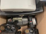 a box full of cameras and a laptop in it