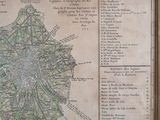 an old map of paris in a wooden frame on a wall