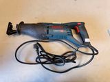 an electric drill is laying on a table next to a cord