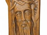 a close up of a carving of a man with a crown on his head