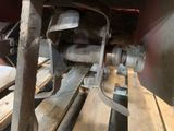 a close up of a machine that is working on a piece of wood