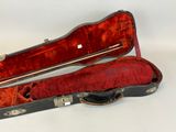 a guitar case that is open on a white surface