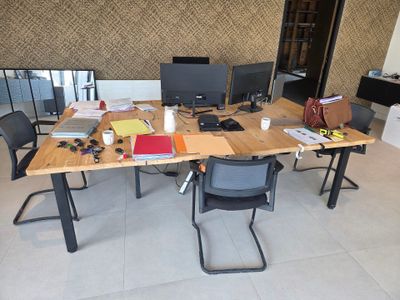 a wooden table with two computer monitors on it