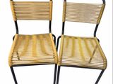 pair of vintage wicker chairs with black metal legs